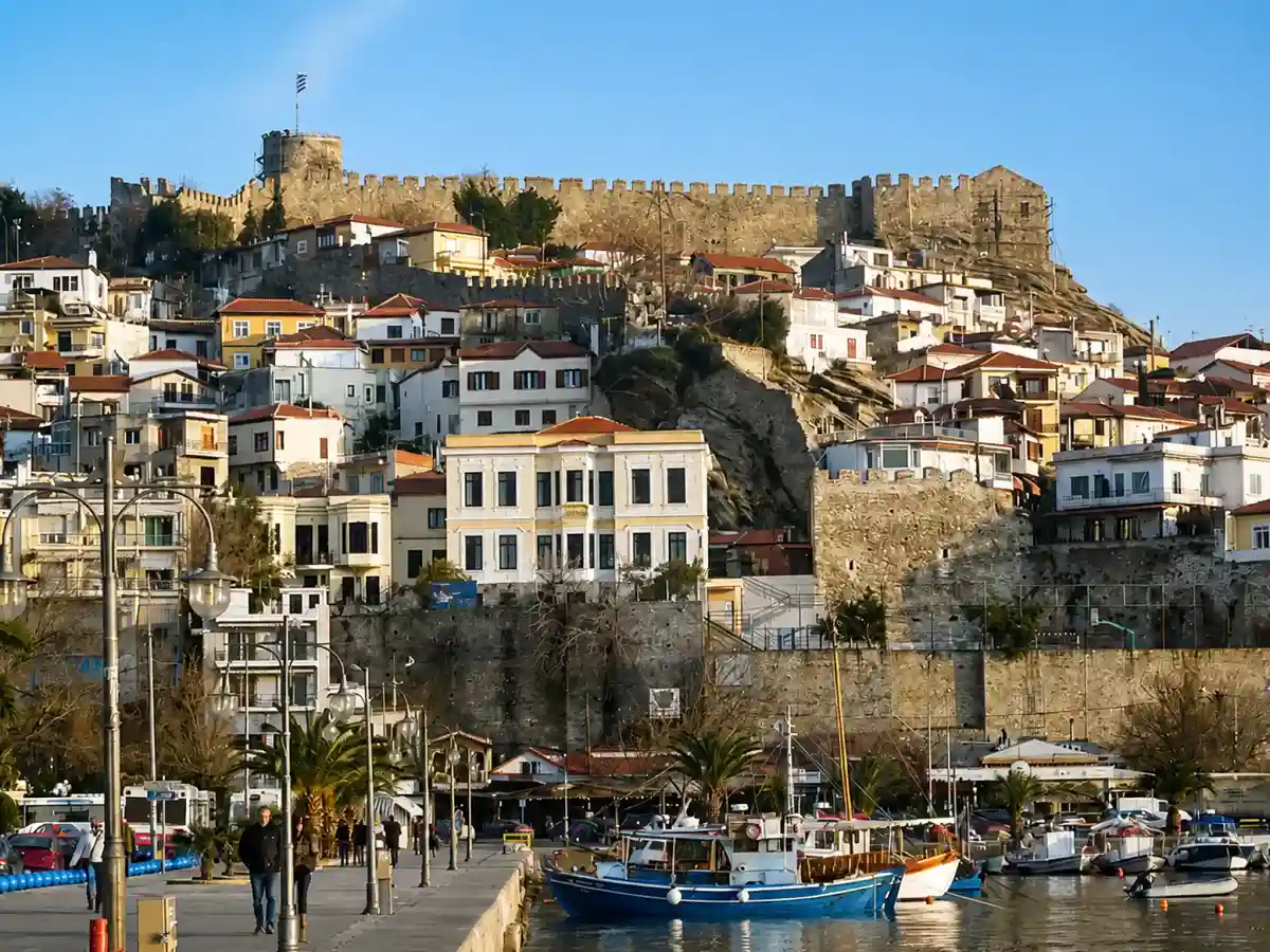 Kavala harbour with fishing boats below the old town of Panagia and the fortress walls